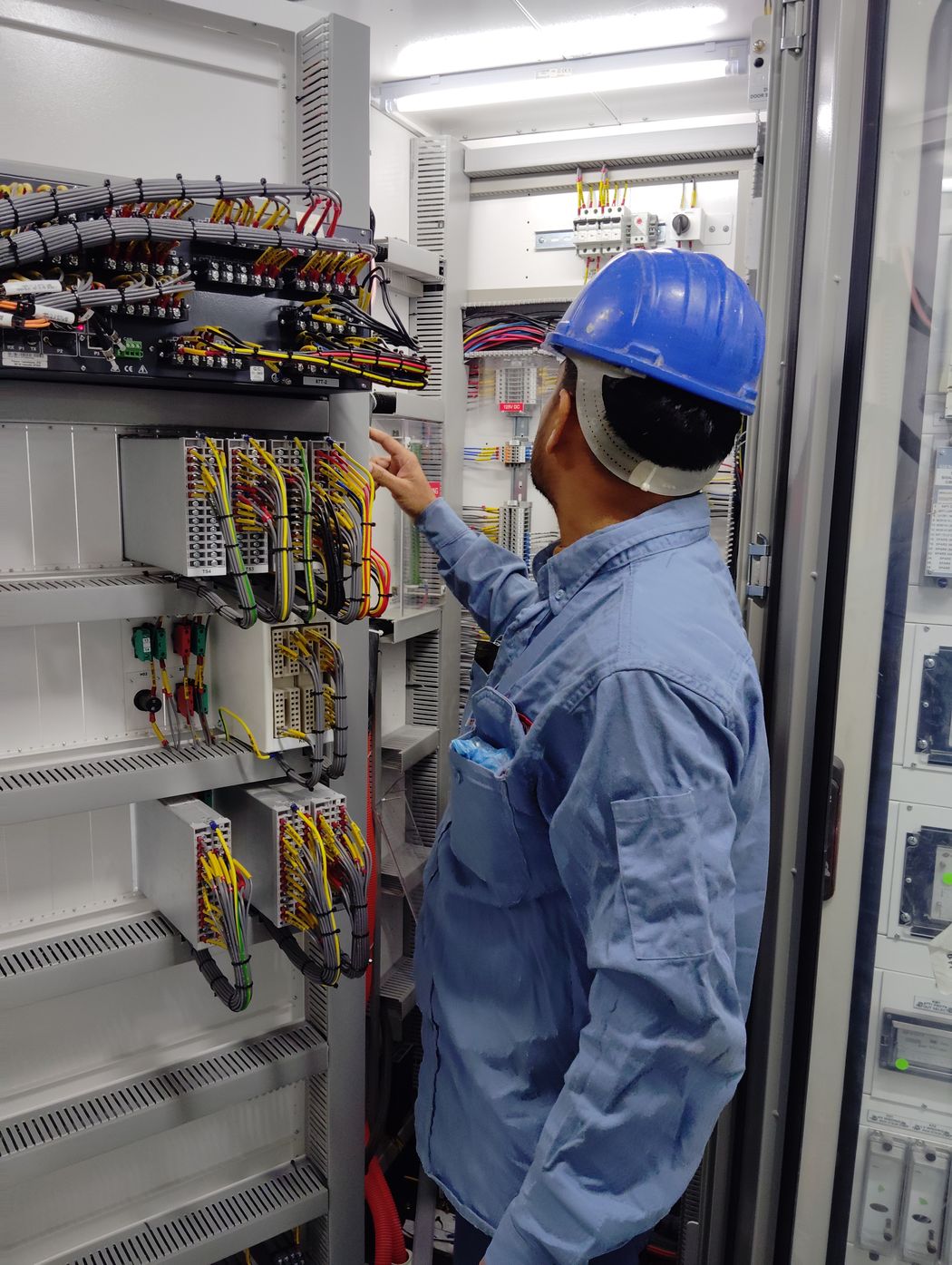 Industrial technician working with a control panel