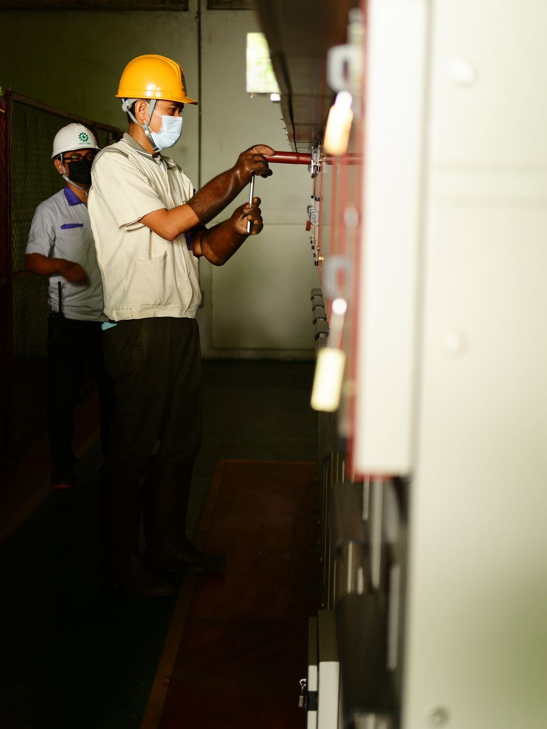Electrical technicians working on industrial control panels