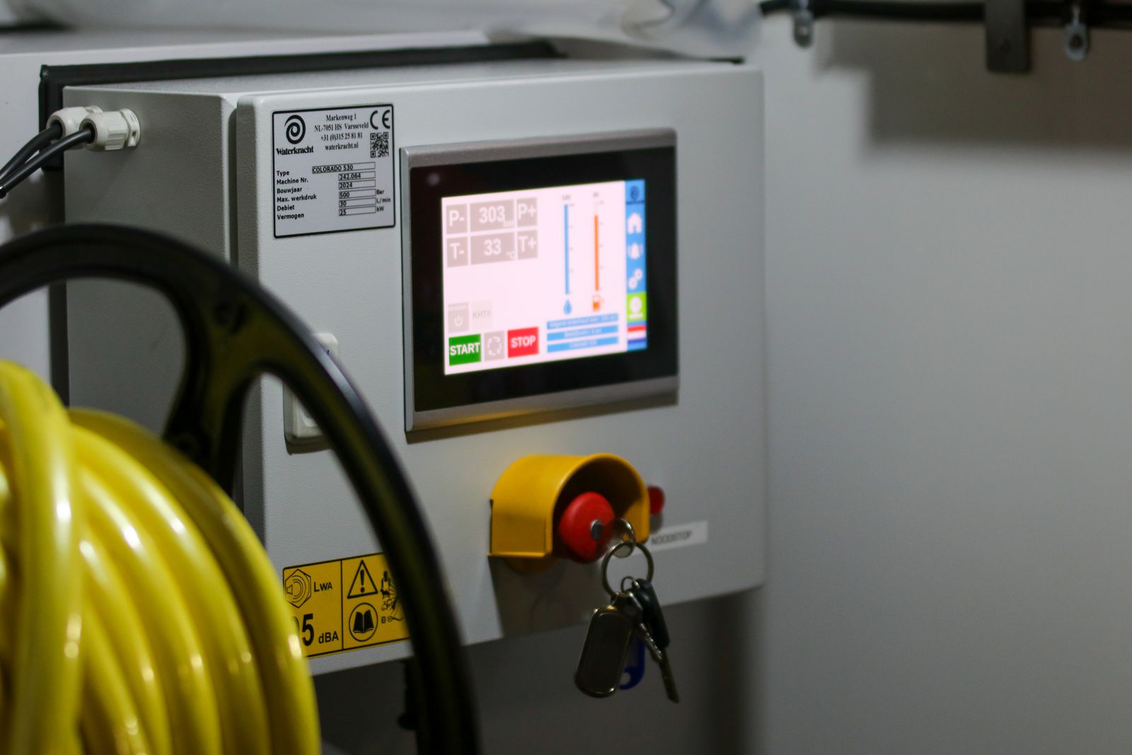 Industrial HMI control panel with digital display and safety controls